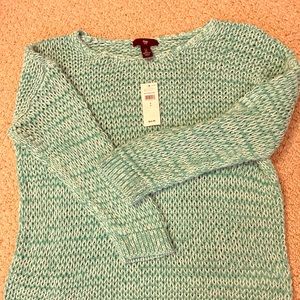 A soft jumper on the baggy side. Brand new. Small